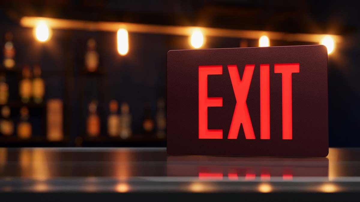 A red isolite exit sign photographed against a blurred background