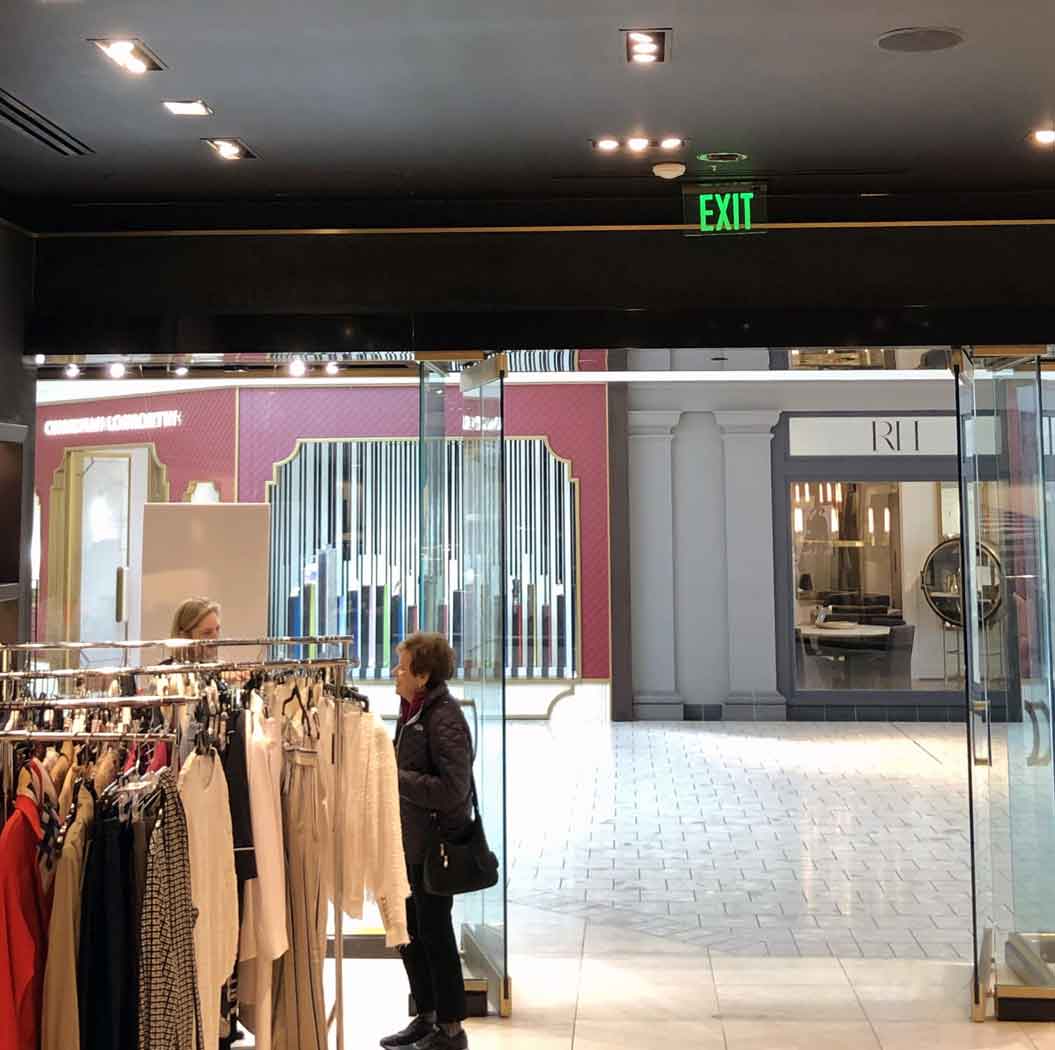 Example of The Isolite Elite Edge-Lit Exit Sign near a clothing store entrance/exit. The Isolite ELT.