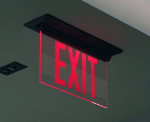 Example of The Isolite Elite Edge-Lit Exit Sign illuminated in hallway. The Isolite ELT.