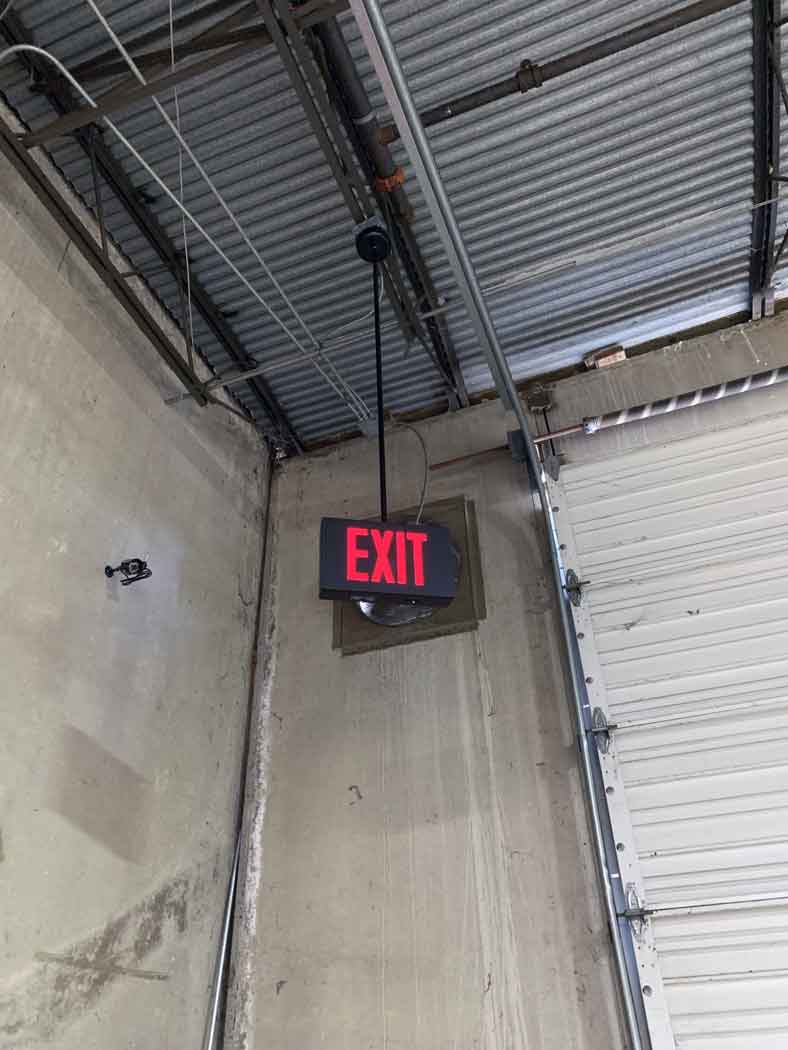 Example of The Isolite LPDC Exit Sign in a warehouse environment. The Isolite LPDC.