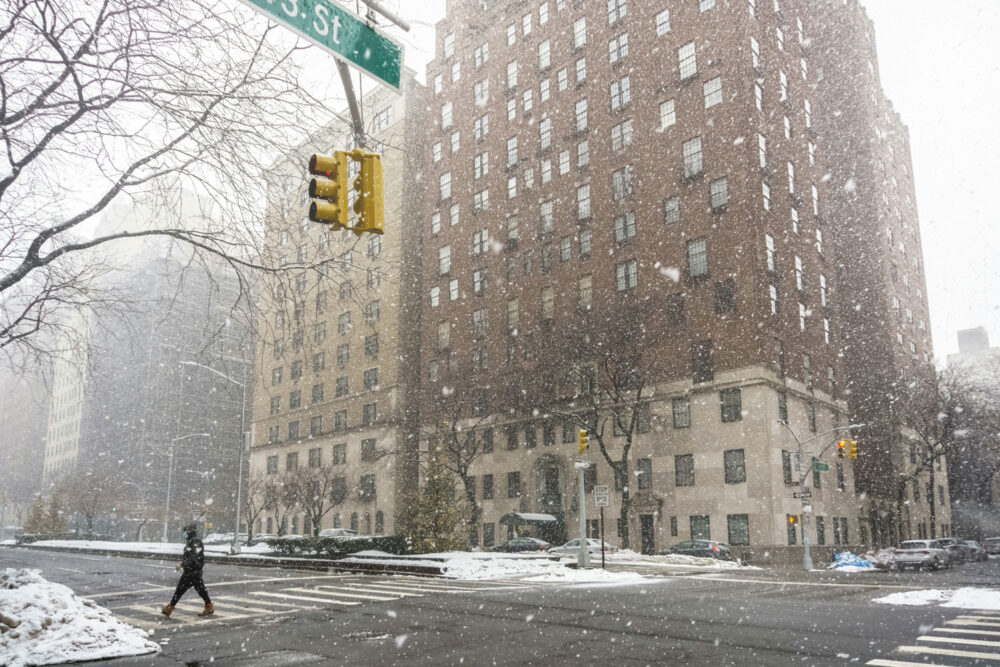 A multi-story office building on a city street corner in the snow