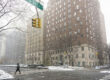 A multi-story office building on a city street corner in the snow