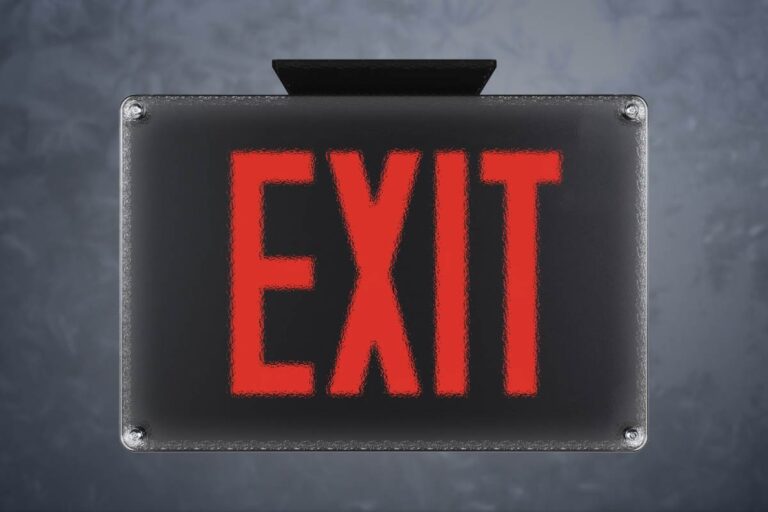 An Isolite exit sign covered by a protective plastic cover